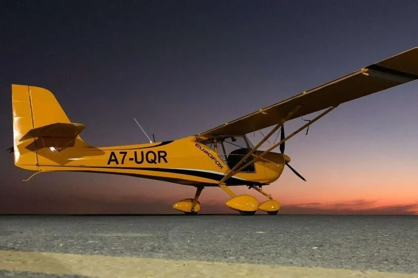 Yellow Piper Archer plane in Qatar during sunset sky