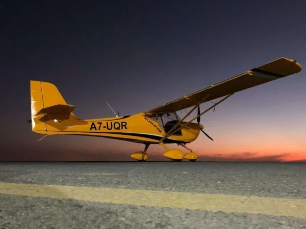 Yellow Piper Archer plane in Qatar during sunset sky