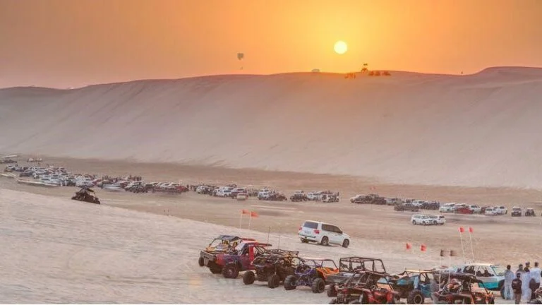 Sunset view of campsite activities at Inland Sea Qatar desert adventure