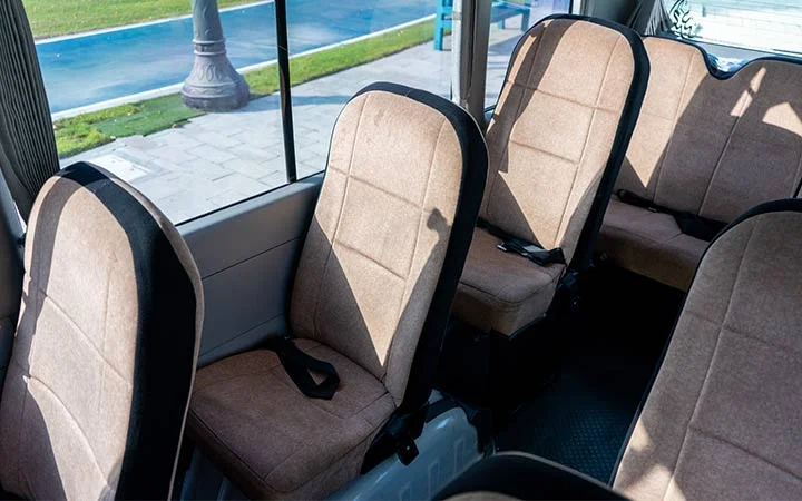 Comfortable seating inside Coaster bus with driver and fuel in Qatar