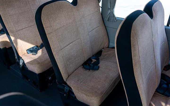Close view of Coaster bus seats with seat belts in Qatar