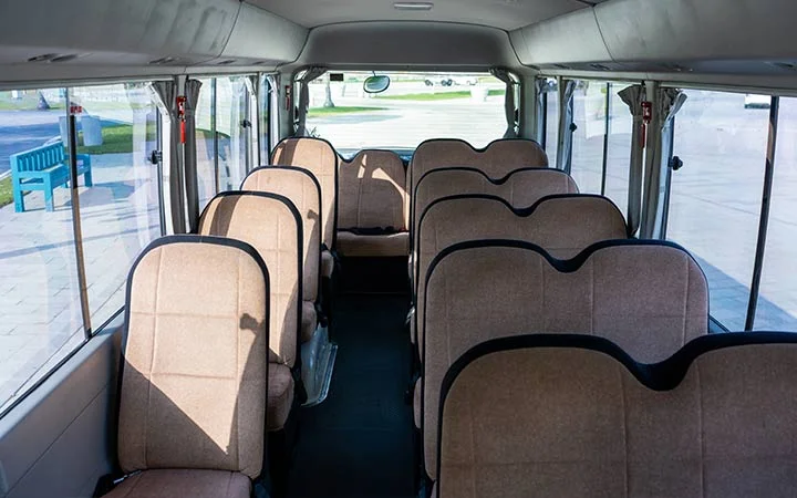 Wide interior view of Coaster bus for group transport in Doha Qatar