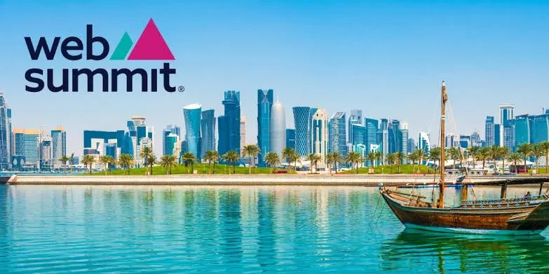 A wooden boat floats on calm water with palm trees and the modern Doha city skyline in the background, highlighting the spirit of Web Summit Qatar 2024. The Web Summit logo appears in the top left corner.
