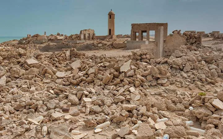 Stone ruins at Al Areesh Ghost Town Qatar showing deserted homes in the desert