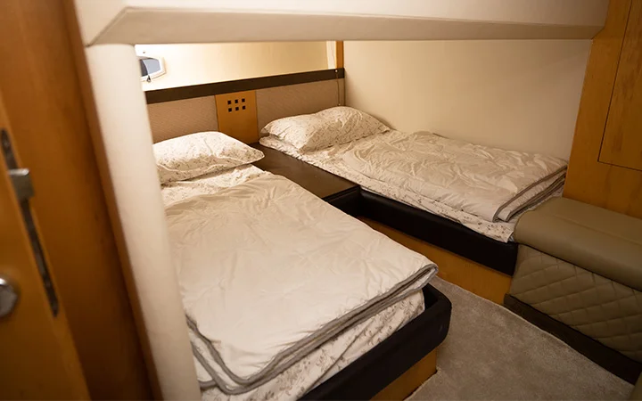 Cozy twin bed cabin inside private yacht rental Qatar