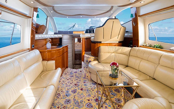 Spacious lounge interior of private yacht in Doha Qatar with leather seating