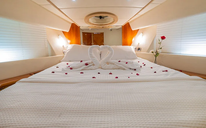 Cozy luxury yacht bedroom in Qatar with decorated bed and ambient lighting