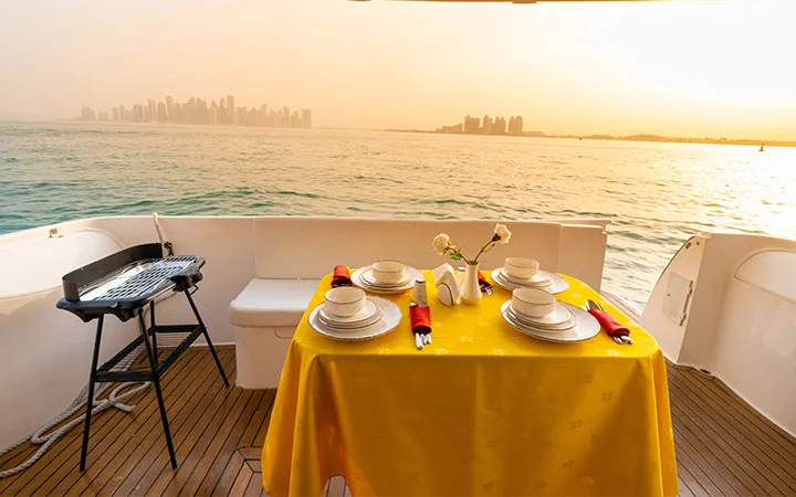 Luxury yacht dining table setup in Doha Qatar with sea view for 12 passengers