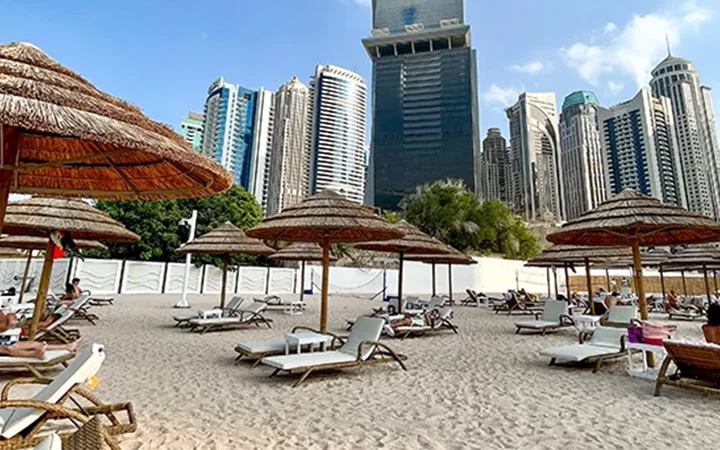 Sandy beach with city towers in Doha