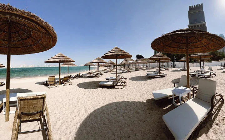 Sunbeds with umbrellas at Doha Sands Beach