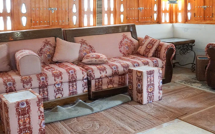 Traditional majlis sofa seating with patterned cushions at Ain Mohamed Village Qatar