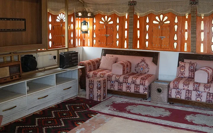 Traditional indoor heritage room with majlis sofa at Ain Mohamed Village Qatar