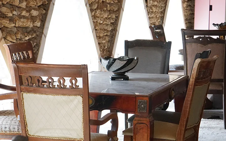 Traditional wooden dining table setup inside Ain Mohamed Village Qatar