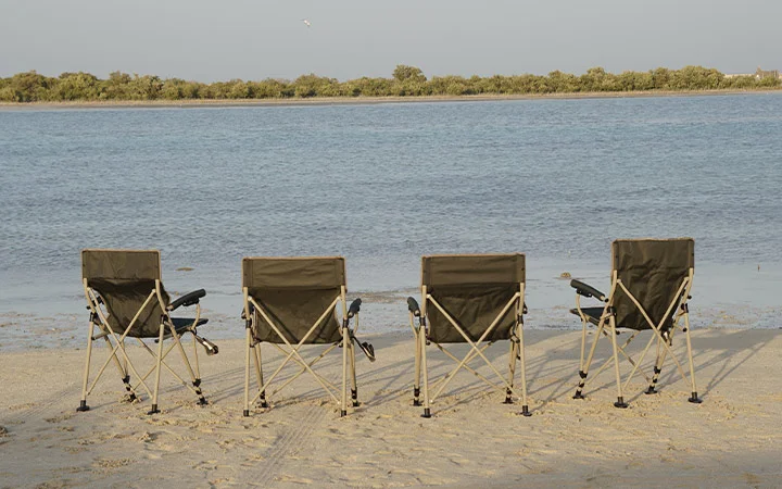 Chairs facing the water at Ain Mohamed Village Qatar beach area