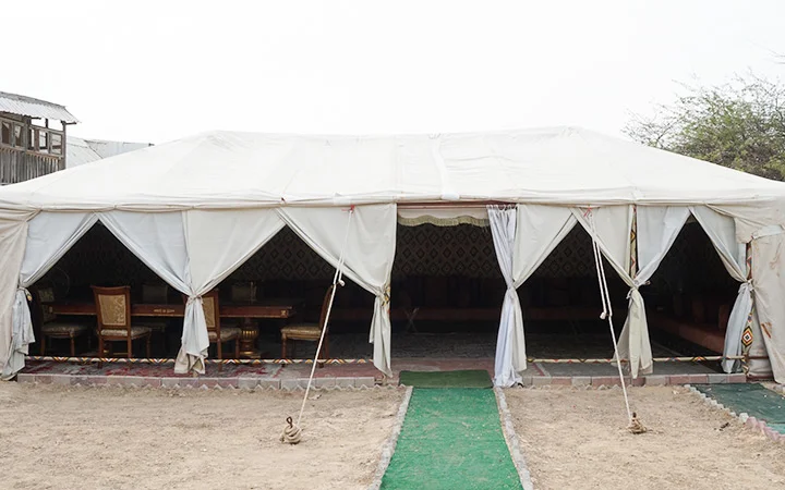Large outdoor tent with seating setup at Ain Mohamed Village Qatar